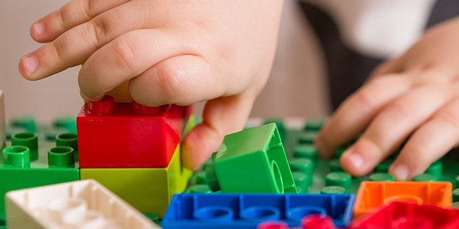 Child playing with Lego blocks