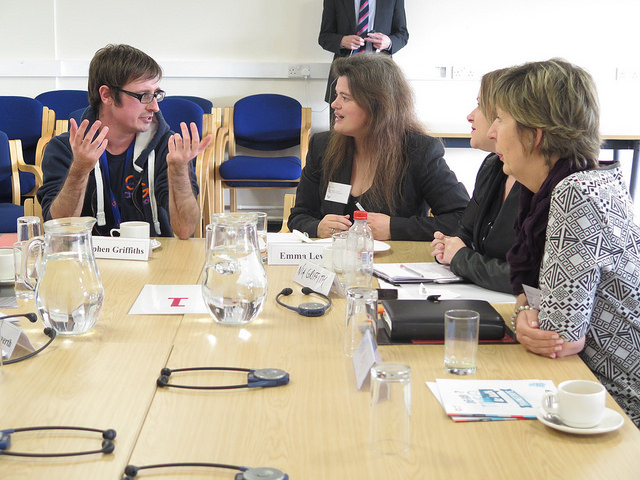 Four participants in discussion around a table at the workshop in Swansea.