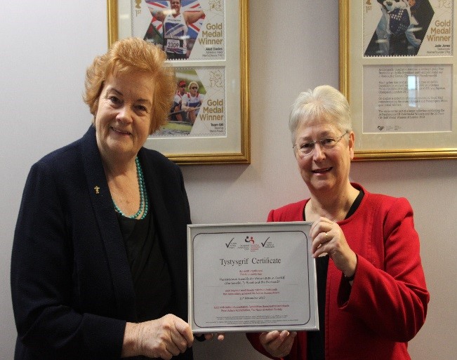 The Presiding Officer, Dame Rosemary Butler, and Sandy Mewies AM, holding the National Autistic Society Autism Access Award