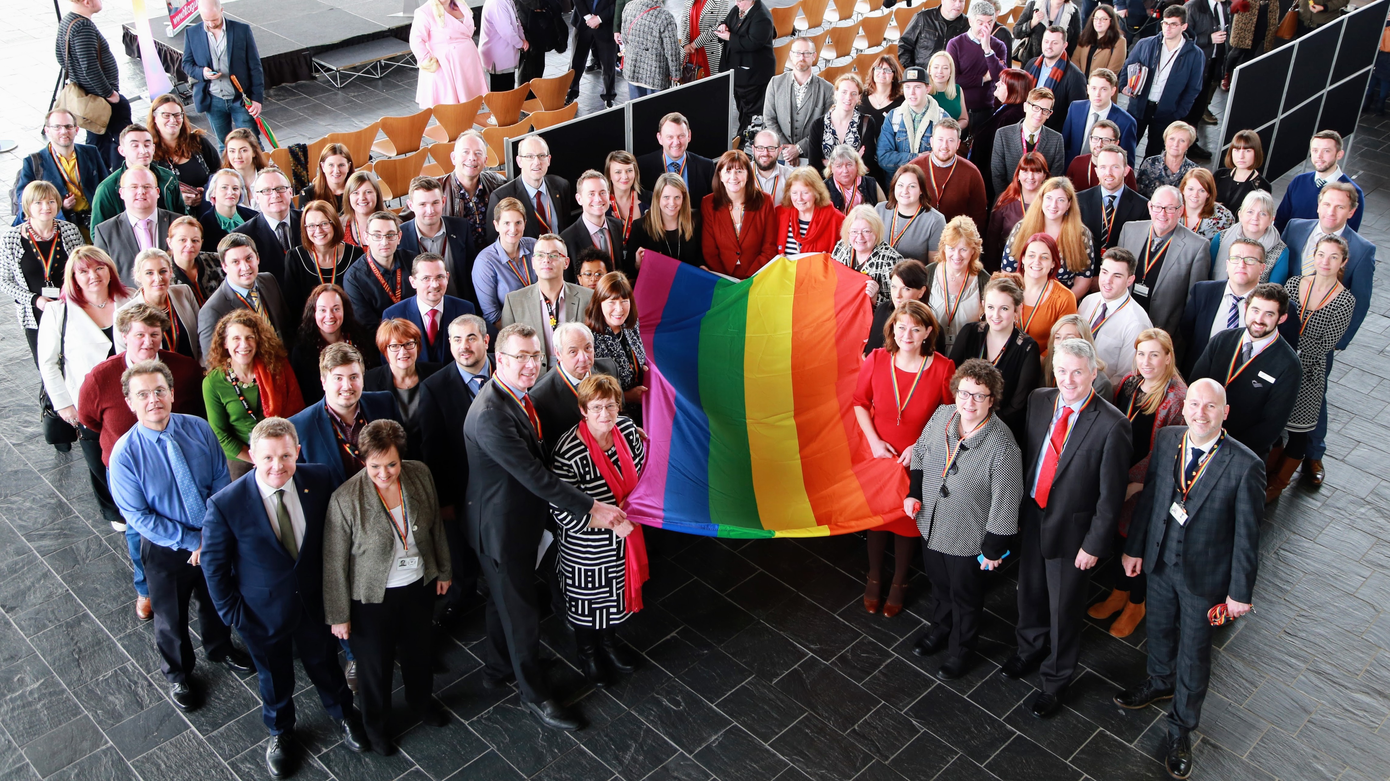 photo of LGBT staff and allies with the rainbow flag