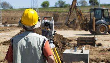 Picture of a construction worker building a road.