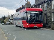 Picture of the T22 Trawscymru bus service passing through a village 