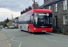 Picture of the T22 Trawscymru bus service passing through a village 