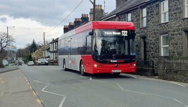 Picture of the T22 Trawscymru bus service passing through a village 