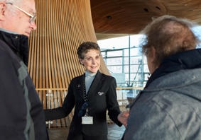 A tour guide showing people around in the Senedd