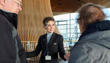 A tour guide showing people around in the Senedd