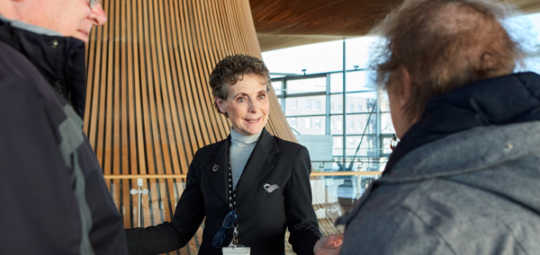A tour guide showing people around in the Senedd