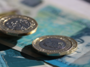 Pound coins and a five pound note.