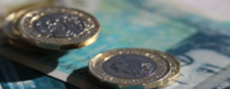 Pound coins and a five pound note.