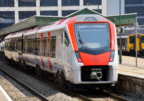 A Transport for Wales train waiting at the platform of a station.