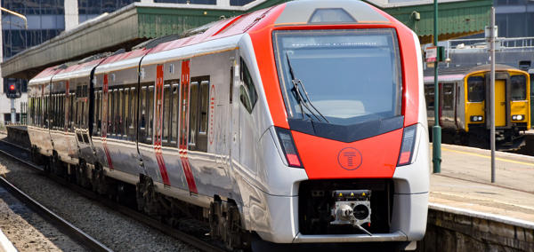 A Transport for Wales train waiting at the platform of a station.