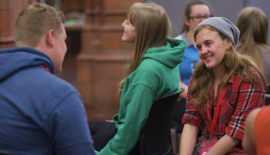 A picture of young people sitting together chatting