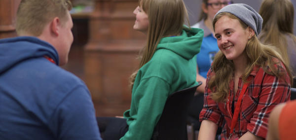A picture of young people sitting together chatting
