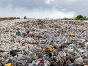 Main image: A landscape photograph of plastic items discarded in landfill.