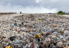 Main image: A landscape photograph of plastic items discarded in landfill.
