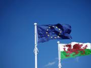 The article’s main image is of Welsh and EU flags against a blue sky.