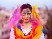 The article’s main image is of a happy person celebrating the Indian festival of Holi with coloured powders.
