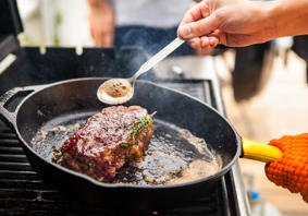 Steak being cooked in a pan