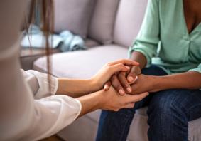 A person holding a hand of another person