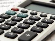 Calculator and pen on piece of paper