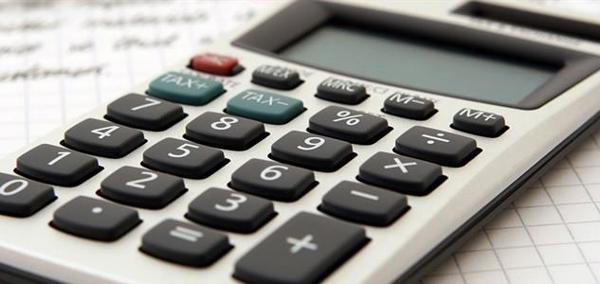 Calculator and pen on piece of paper