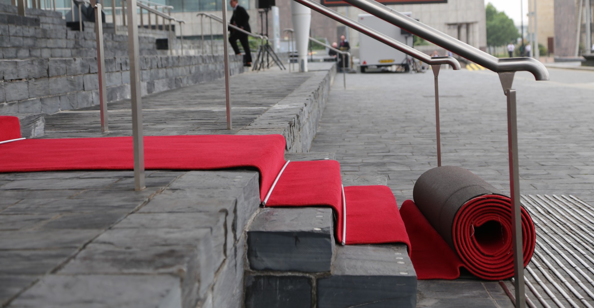 A roll of red carpet on the steps of the Senedd.