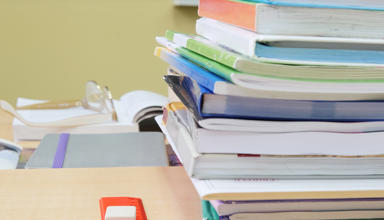 Image of school books on a desk 