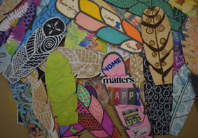 A collection of member’s feathers designed with decorative symbols and meaningful messages and images of hope. 