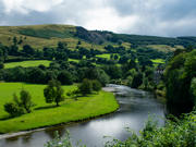 Image of river bend in a Welsh farming landscape, with hilltop quarry in the distance.