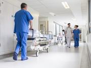A hospital corridor, nurses are talking and caring for patients