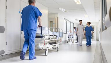 A hospital corridor, nurses are talking and caring for patients