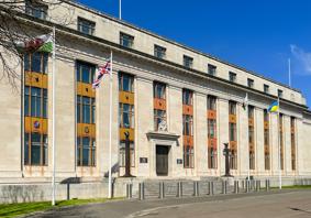 A picture of the outside of the government building in Cathays. The Welsh, UK and Ukraine flags are visible.