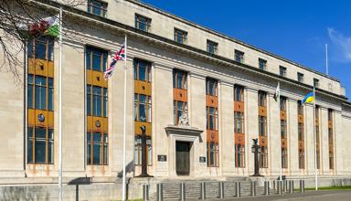 A picture of the outside of the government building in Cathays. The Welsh, UK and Ukraine flags are visible.