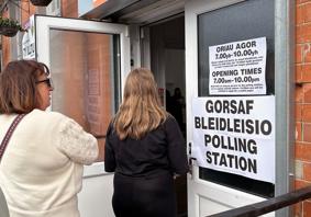 Two people entering a polling station