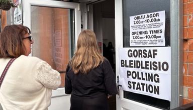 Two people entering a polling station