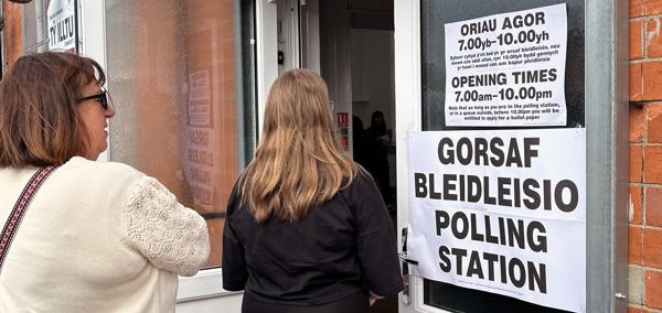 Two people entering a polling station