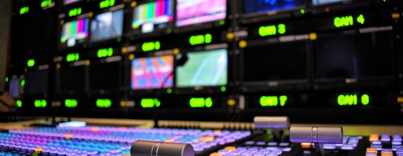 Broadcasting desk with television screens and control panel